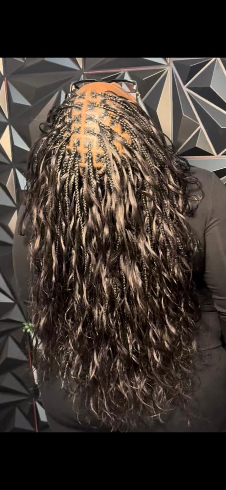 Long boho braids with curly ends at Braids by estal